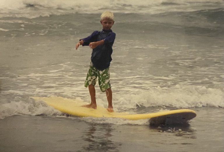 Tyler Decker as a kid on a surfboard